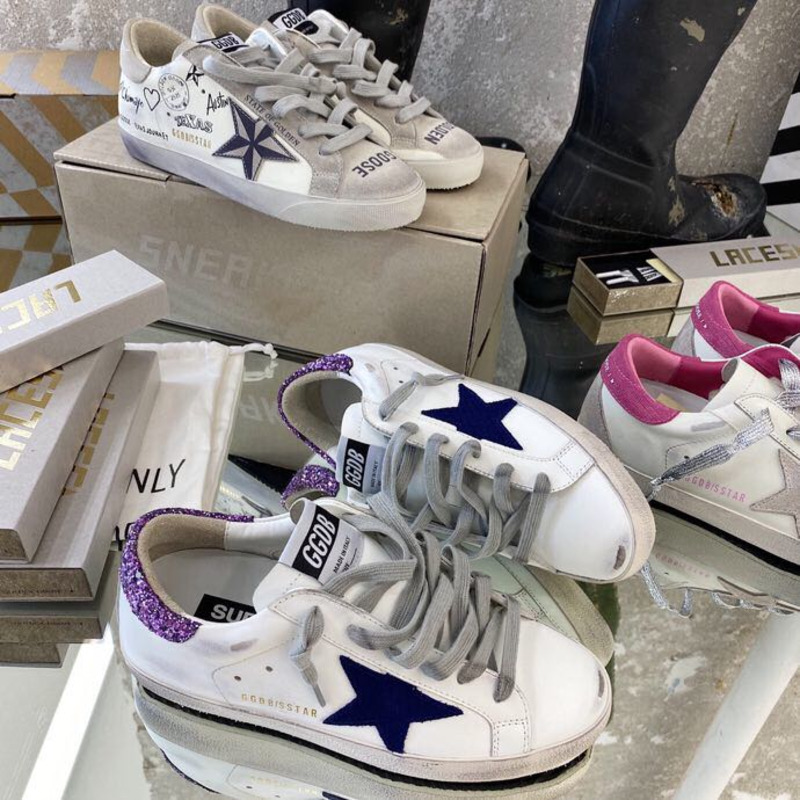 white S*per-star sneakers with blue star and glittery heel tab